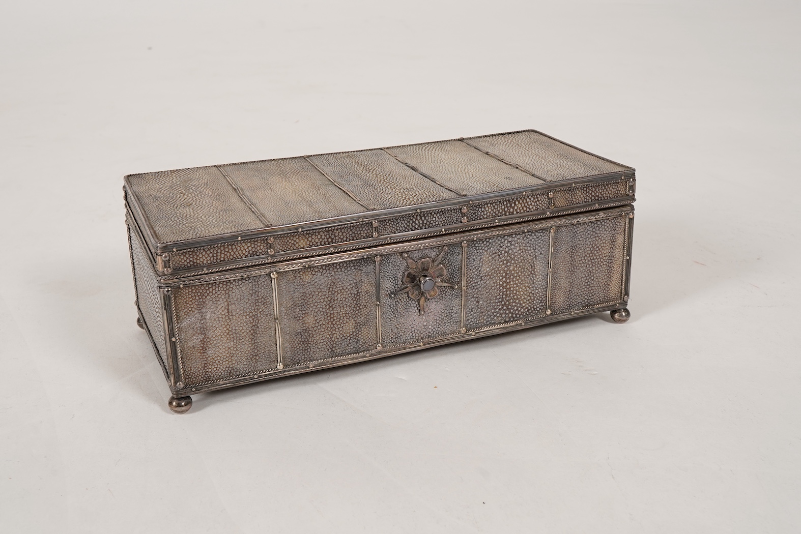 An early 20th century Arts & Crafts silver and shagreen mounted cigarette box with hinged cover, by John Paul Cooper